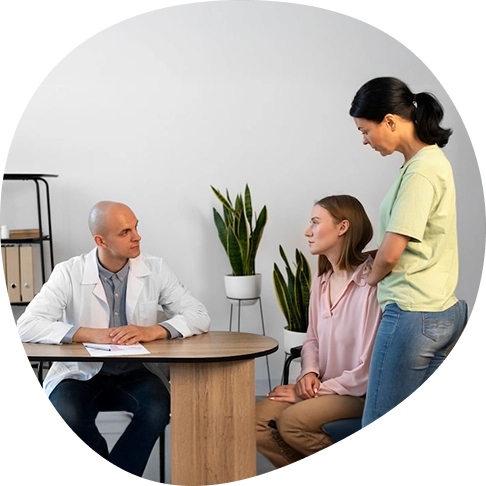 Psychiatrist welcoming a new patient and family during an initial mental health appointment.