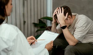 Patient discussing anxiety symptoms with a mental health therapist