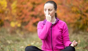 Person practicing box breathing outdoors for stress and anxiety relief