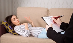 Therapist using psychiatry worksheets and patient questionnaires during counseling
