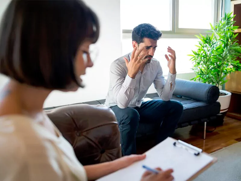 Therapist helping a patient manage anxiety through counseling and therapy
