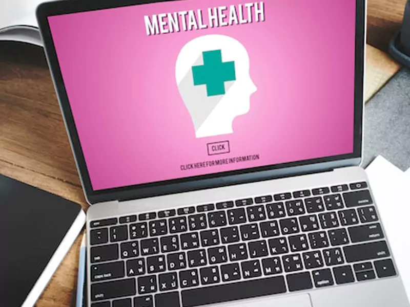 Laptop displaying LGBTQ+-affirming mental health care and online therapy resources