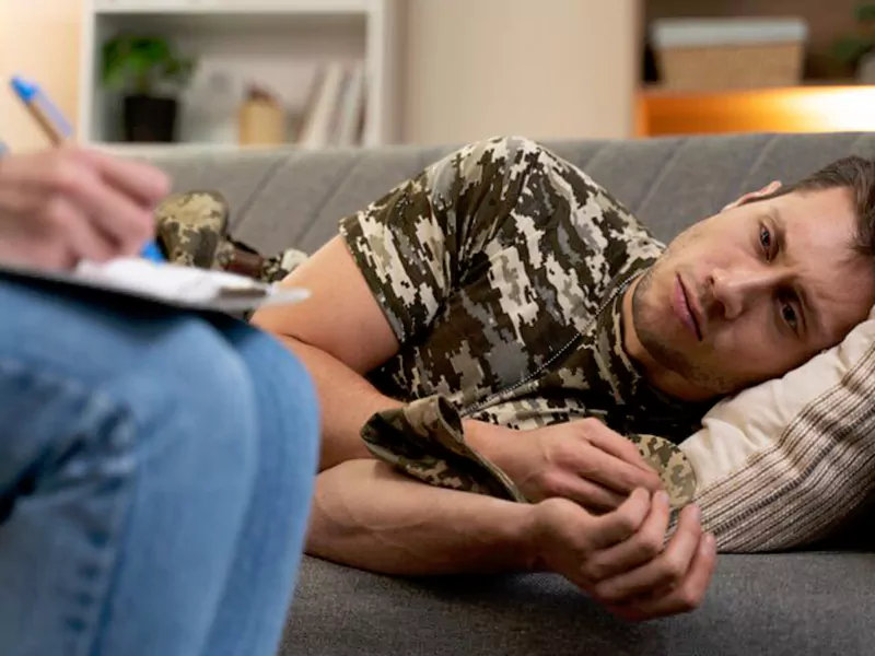 Patient attending PTSD treatment session with a licensed mental health therapist